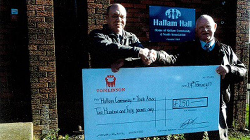 Tomlinson presenting a cheque to Hall Manager Alan Bone